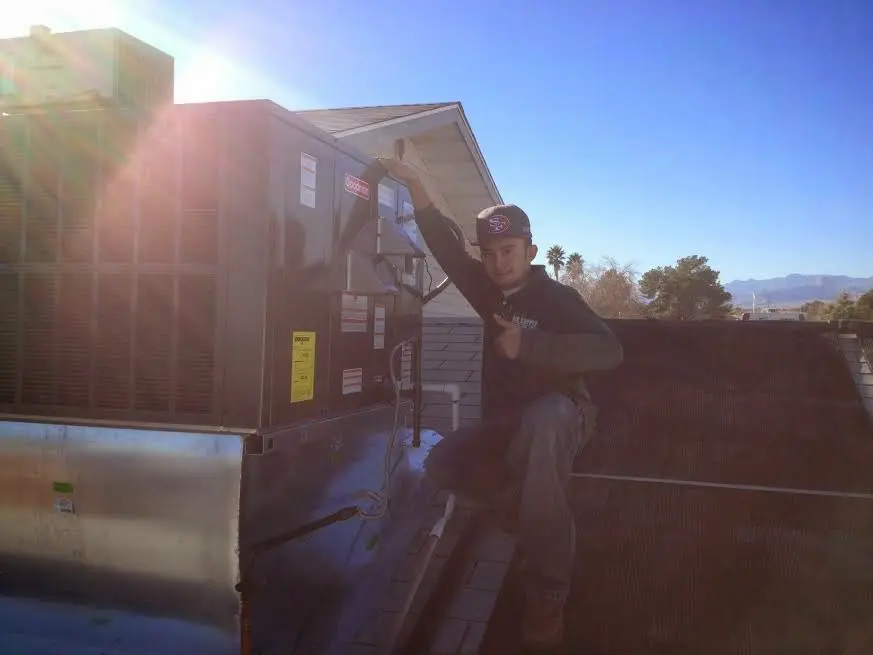 HVAC technician performing HVAC Inspection on a rooftop unit in Wood-Ridge